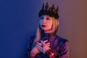 Woman wearing a gothic queen outfit